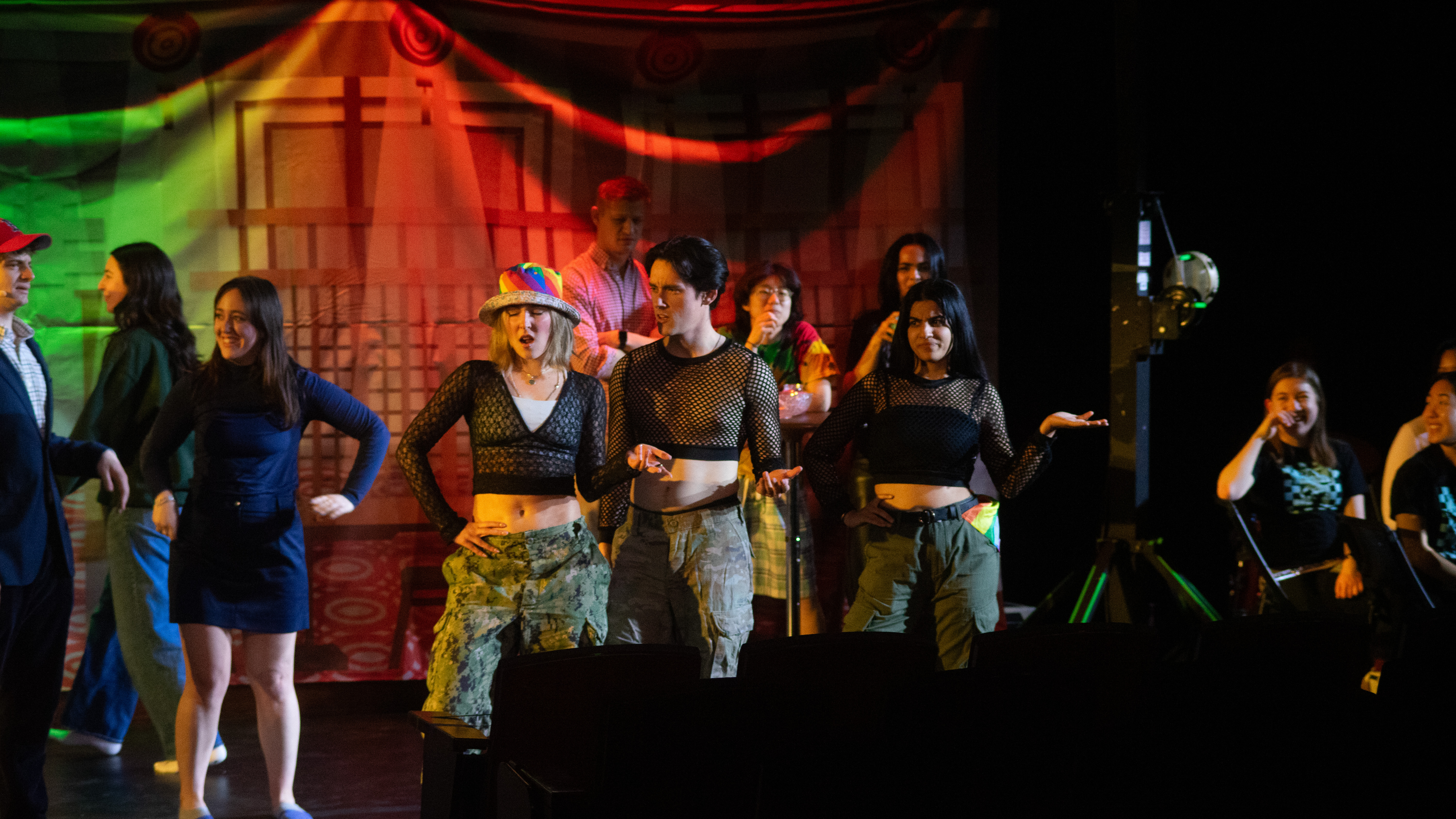 Various players, from left to right: "Law-nguini" (in a red hat, slightly cut off, Dennis Ronel, HLS '26), Cold Collette (Scarlett Neely, HLS '25) and other members of the ensemble.
