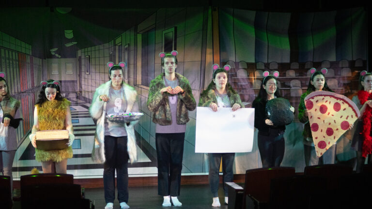 List of various HLS Parody Players in character as rats, including In Rem-y (appearing in brown due to the lighting, Kate Hostal, HLS '25) (HLS Drama Society, 2025).